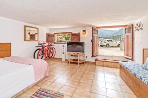 a bedroom with a bed and a bike in a room at Cas Mariner Puerto de Sóller in Port de Soller