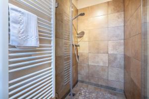 a bathroom with a shower with a glass door at Ferienwohnung Zwiesel in Wackersberg +10 photos