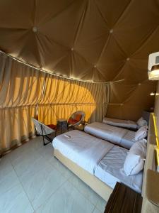 a bedroom with two beds in a tent at Hamod in Wadi Rum