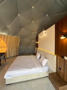 a bedroom with a bed in a tent at Hamod in Wadi Rum
