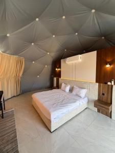 a bedroom with a large bed in a tent at Hamod in Wadi Rum