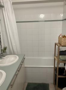a bathroom with a white tub and a sink at Maison en Drôme Provençale in Nyons +18 photos