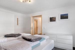two beds in a room with white walls at Ferienwohnung Wanne im Schwarzwald in Furtwangen