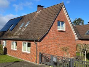 a red brick house with solar panels on the roof at Ferienwohnung, Schwerin in Schwerin