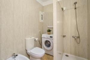 a bathroom with a toilet and a washing machine at Sun and Calm Las Floritas in Playa de las Americas +19 photos
