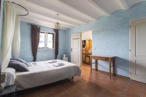 a bedroom with a bed and a desk in it at Tour Catalane in Ille-sur-Têt