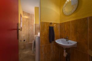 a bathroom with a sink and a mirror on the wall at Tour Catalane in Ille-sur-Têt