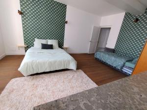 a bedroom with a bed and a mirror and a rug at Gite cozy, Parc naturel du Morvan in Lormes