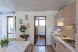 a kitchen with a sink and a stove top oven at Casa Rita app 4 A in Tremosine Sul Garda