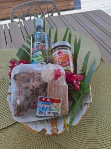a basket of food and drinks and flowers on a table at Villa SELAH in Le Moule