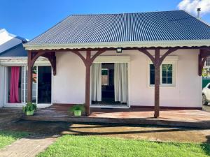 a small white house with a roof at Villa SELAH in Le Moule