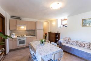 a living room with a table and a couch at Casa Rita app 4 A in Tremosine Sul Garda