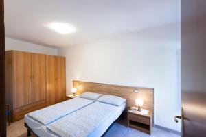 a bedroom with a large bed and two night stands at Casa Rita app 4 A in Tremosine Sul Garda