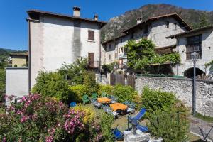 a group of chairs and tables in front of a building at Casa Rita app 4 A in Tremosine Sul Garda