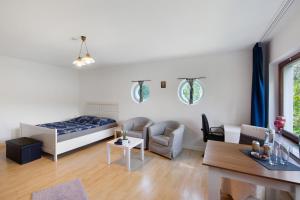 a bedroom with a bed and a living room at Ferienwohnung Waldblick in Remscheid