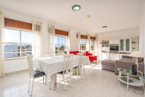 a kitchen and living room with a white table and chairs at Maralvor 301 in Alvor