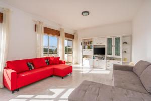 a red couch in a large living room with a red couch at Maralvor 301 in Alvor
