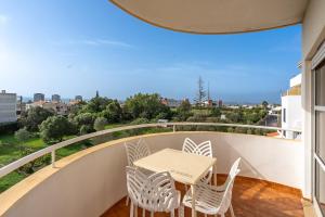 a table and chairs on a balcony with a view at Maralvor 301 in Alvor