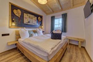 a bedroom with a large bed in a room at Luxus-Chalet Mühlberg in Eppenschlag