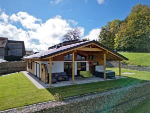 a pavilion with a roof on a garden at Luxus-Chalet Mühlberg in Eppenschlag