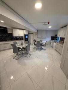 a large kitchen with a table and chairs in it at Wild Atlantic Inn in Lisdoonvarna