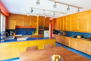a kitchen with wooden cabinets and a wooden table at Espace, Luxe, Calme Et Nature in Saint-Martin-de-Seignanx