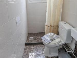 a bathroom with a toilet with a roll of toilet paper at Nikiana Sailing Beach Club in Nikiana +14 photos