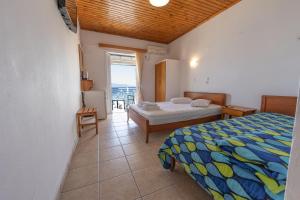 a bedroom with a bed and a table and a window at Nikiana Sailing Beach Club in Nikiana