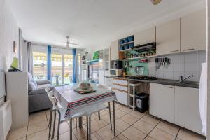 a kitchen and living room with a table and chairs at Appartement proche plage Parentis in Parentis-en-Born +12 photos