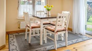 a dining room table with four chairs and a table at Ferienwohnung Strempel in Templin