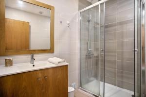 a bathroom with a shower and a sink at A O - Apartamento Gâmboa in Peniche +15 photos