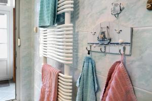 a bathroom with towels hanging on a wall at Ferienwohnung Strempel in Templin +11 photos