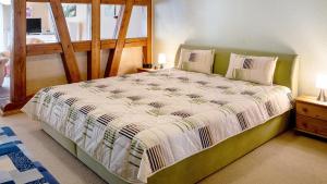 a bedroom with a large bed with a wooden frame at Ferienwohnung Strempel in Templin