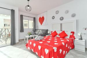 a bedroom with a red bed with red pillows at Nerja Boutique 102 Deluxe in Nerja