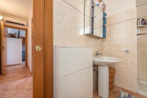 a bathroom with a sink and a mirror at Casa Vacanze 21 Aprile - 1 in Calasetta +20 photos