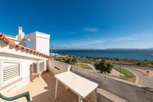 a balcony with a table and a view of the ocean at Casa Vacanze 21 Aprile - 1 in Calasetta