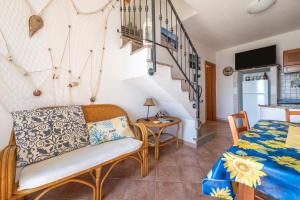 a living room with a couch and a table at Casa Vacanze 21 Aprile - 1 in Calasetta
