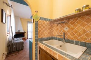 a kitchen with a sink in a room at Casa Delle Pomelie in Trappeto +27 photos