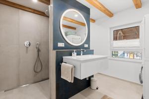a bathroom with a sink and a mirror at Fewo Bergfeld in Mosbach +20 photos