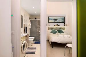 a bedroom with a bed and a bathroom at Smart Home Loano in Loano +16 photos
