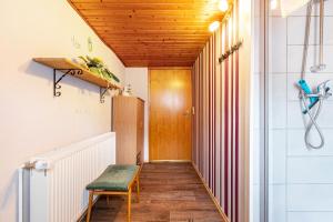 a hallway with a wooden door and a chair at Altstadt Ferienhaus mit Terrasse in Husum +16 photos