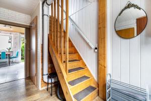 a wooden staircase in a house with a mirror at Altstadt Ferienhaus mit Terrasse in Husum