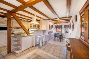 a kitchen with wooden ceilings and a table and chairs at Feriendomizil Berta Benzingen 2 in Winterlingen +20 photos