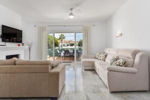 a living room with two couches and a fireplace at Penthouse Jacaranda in Estepona