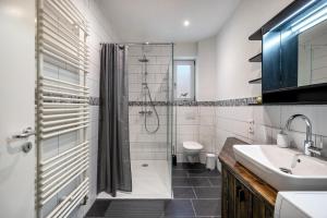 a bathroom with a shower and a sink at Klönstuv in Breklum +19 photos
