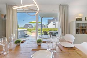 a dining room with a table with wine glasses at Haus Seeblick in Göhren-Lebbin