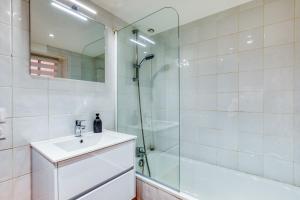 a bathroom with a sink and a glass shower at La Reine in Béziers