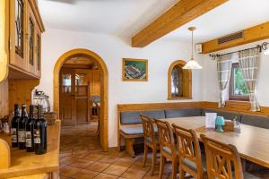 a kitchen and dining room with a wooden table and chairs at Gasthaus Mamoosen in Penning