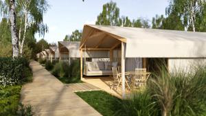 a house with a white canopy in a garden at Eco Camping in Spytkowice