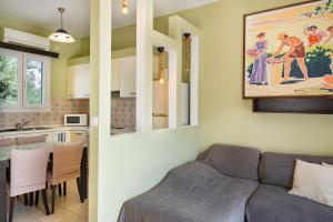 a living room with a couch and a kitchen at Anemi Leros Apartments 1 in Panteli +14 photos